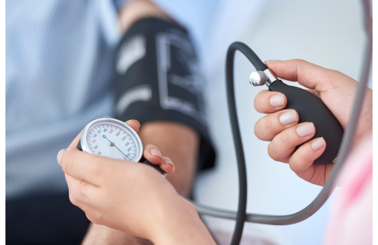 Blood Pressure Check A healthcare professional measuring blood pressure with a sphygmomanometer.