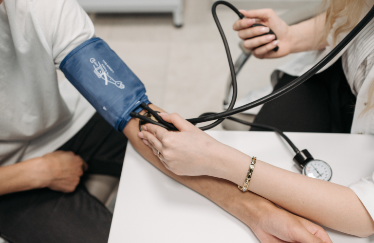 Infection Control A healthcare worker cleans a table in a hospital setting while patients are treated nearby.