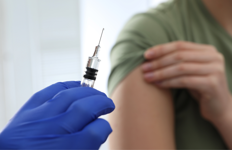 Diabetic Foot Assessment A person receiving foot care, with hands pointing to the ankle area.